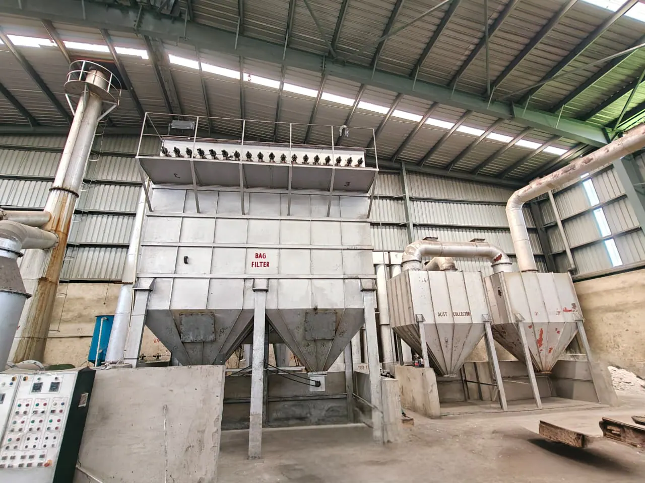 Installed bag-filter housing and dust-collector equipment connected within an industrial plant