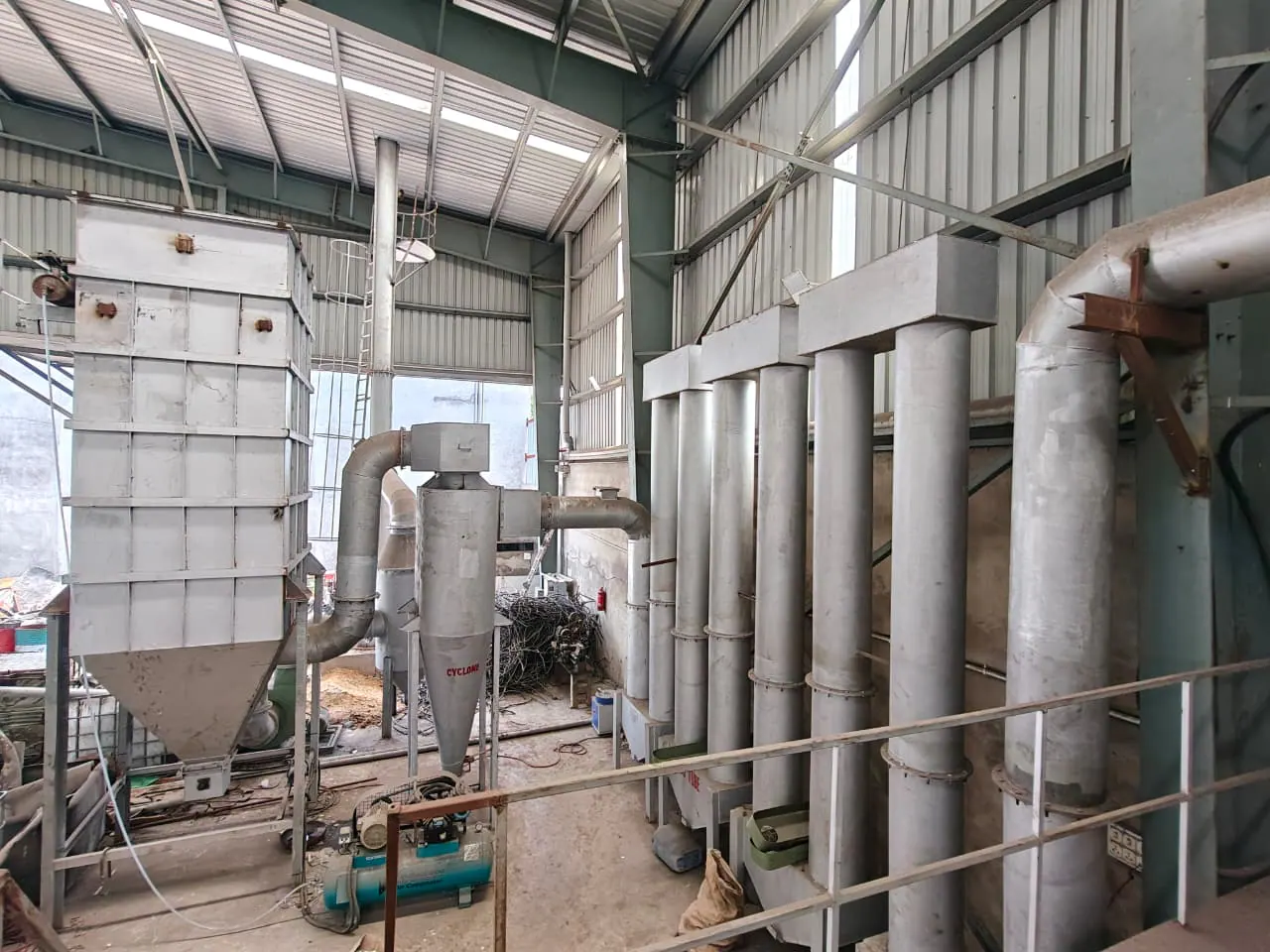Installed cyclone separator beside a hopper enclosure, vertical tube bank and connecting ductwork